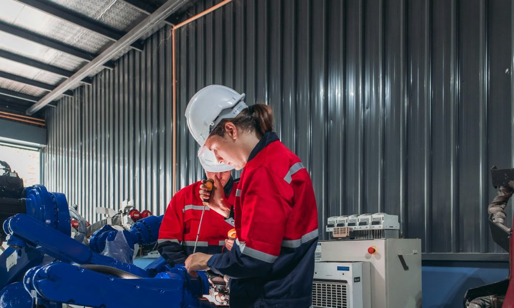 Technician Conducting Electrical Safety Check on Robot